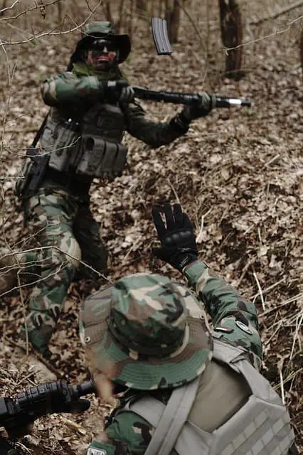 Two airsoft players fighting together