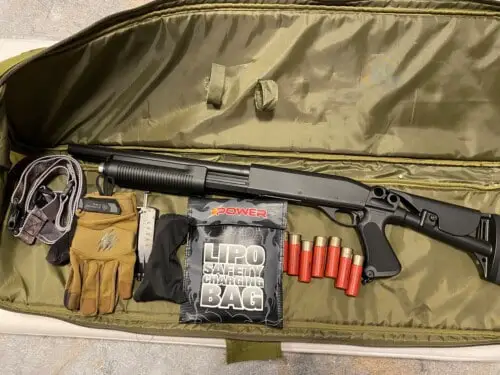 an airsoft gun bag with a shotgun, shells, gloves, sling and batteries